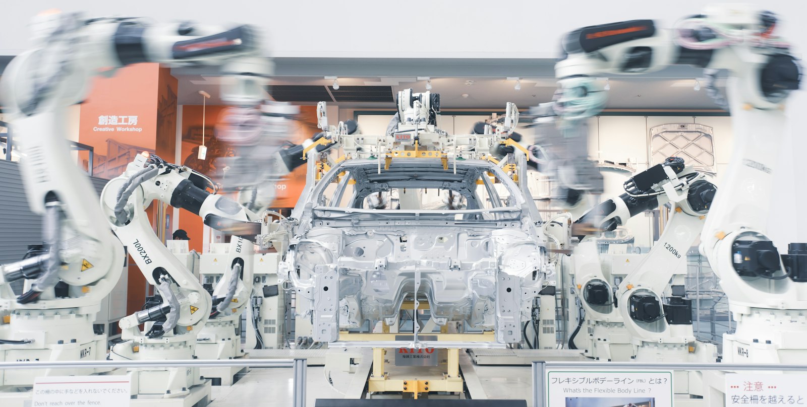 Robotic arms assembling a car chassis on a factory line